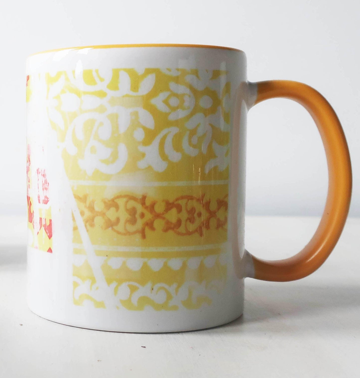 Mug with yellow and white pattern on a white background
