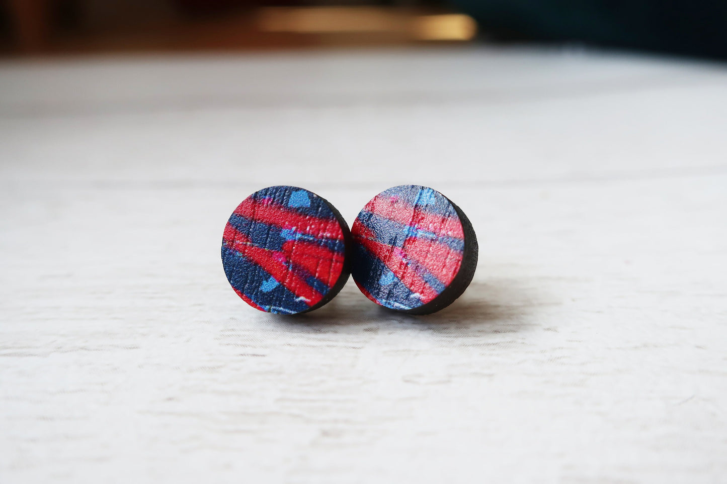 Plaid patterned earrings on a white surface
