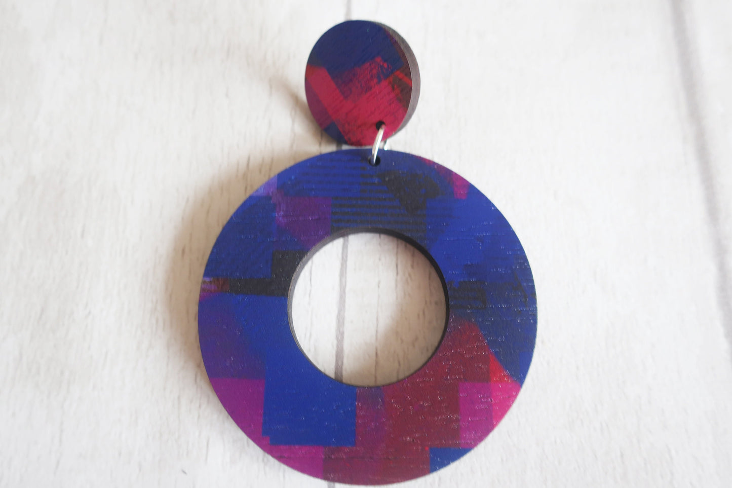 Multicolored circular earring on a white background