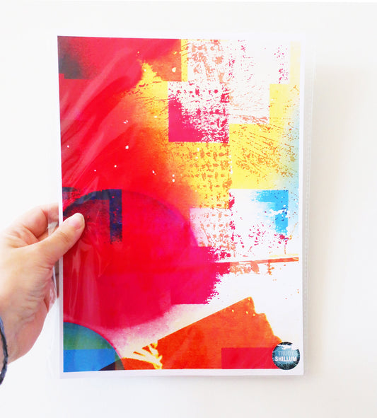 Colorful abstract art print held by a hand on a white background