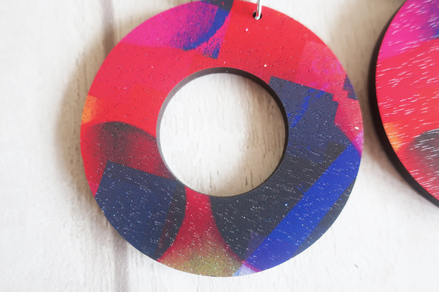 Colorful circular earrings on a white background