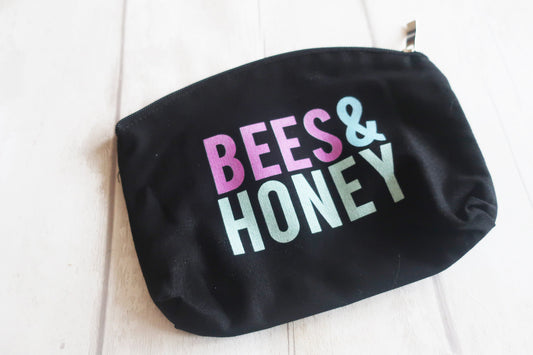 Black pouch with 'BEES & HONEY' text on a white background