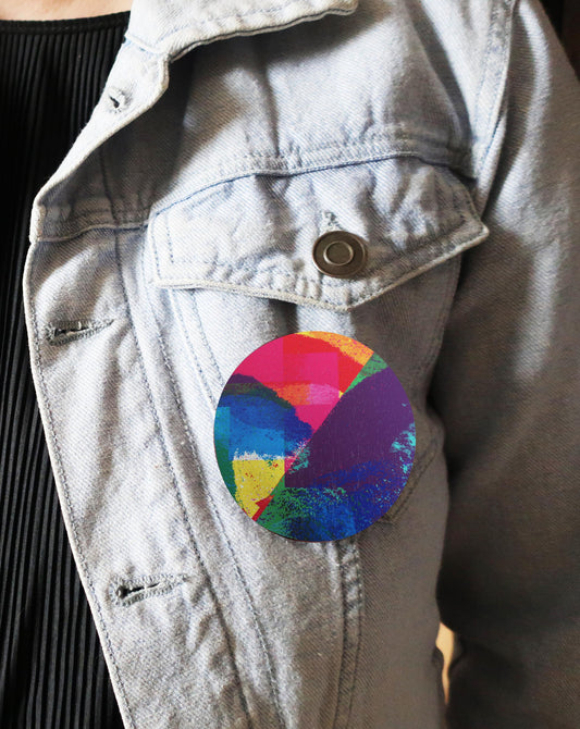 Colorful circular brooch on a denim jacket