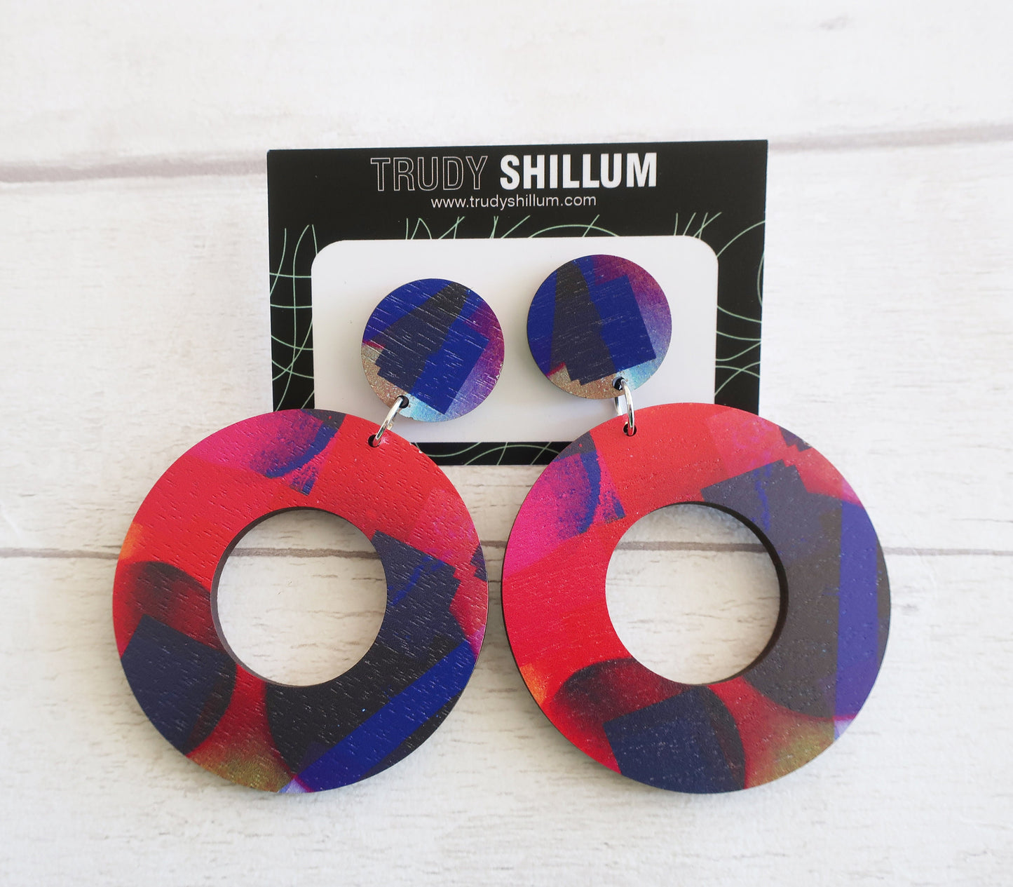 Colorful circular earrings on a white background with 'Trudy Shillum' packaging.