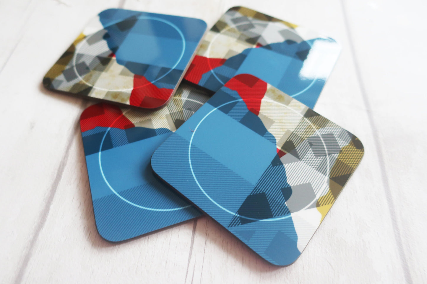Set of geometric patterned coasters on a white surface