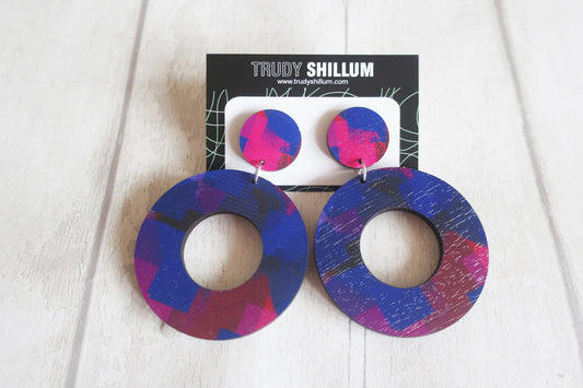 Colorful circular earrings on a Trudy Shillum branded card against a white background