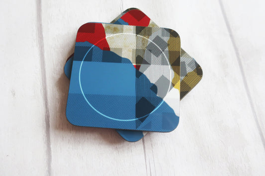 Set of colorful square coasters on a light wooden surface