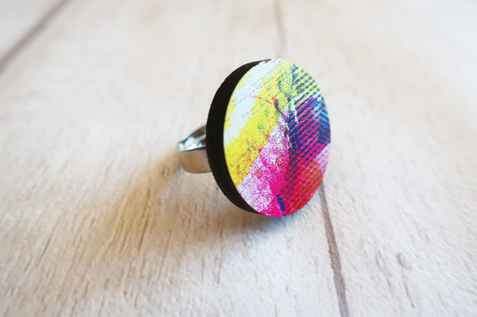 Colorful ring with abstract design on a wooden surface