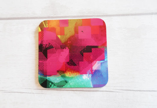 Colorful geometric coaster on a white wooden surface
