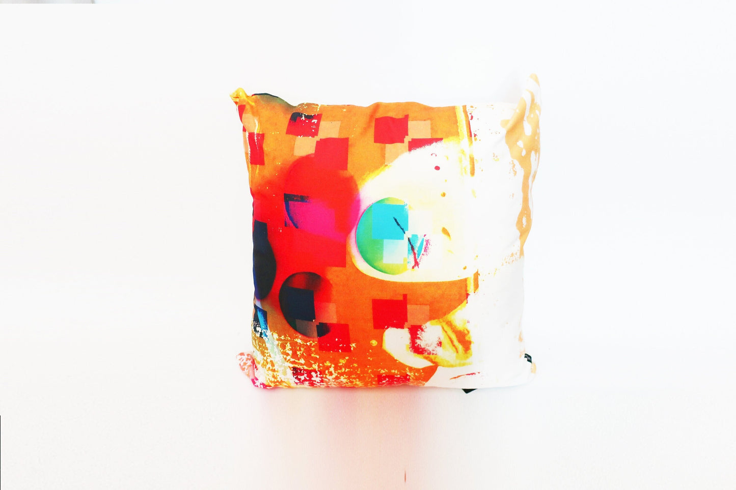 Colorful cushion with geometric pattern on a white background