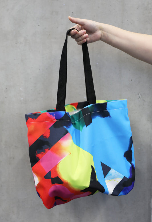 colourful tote bag being held by hand