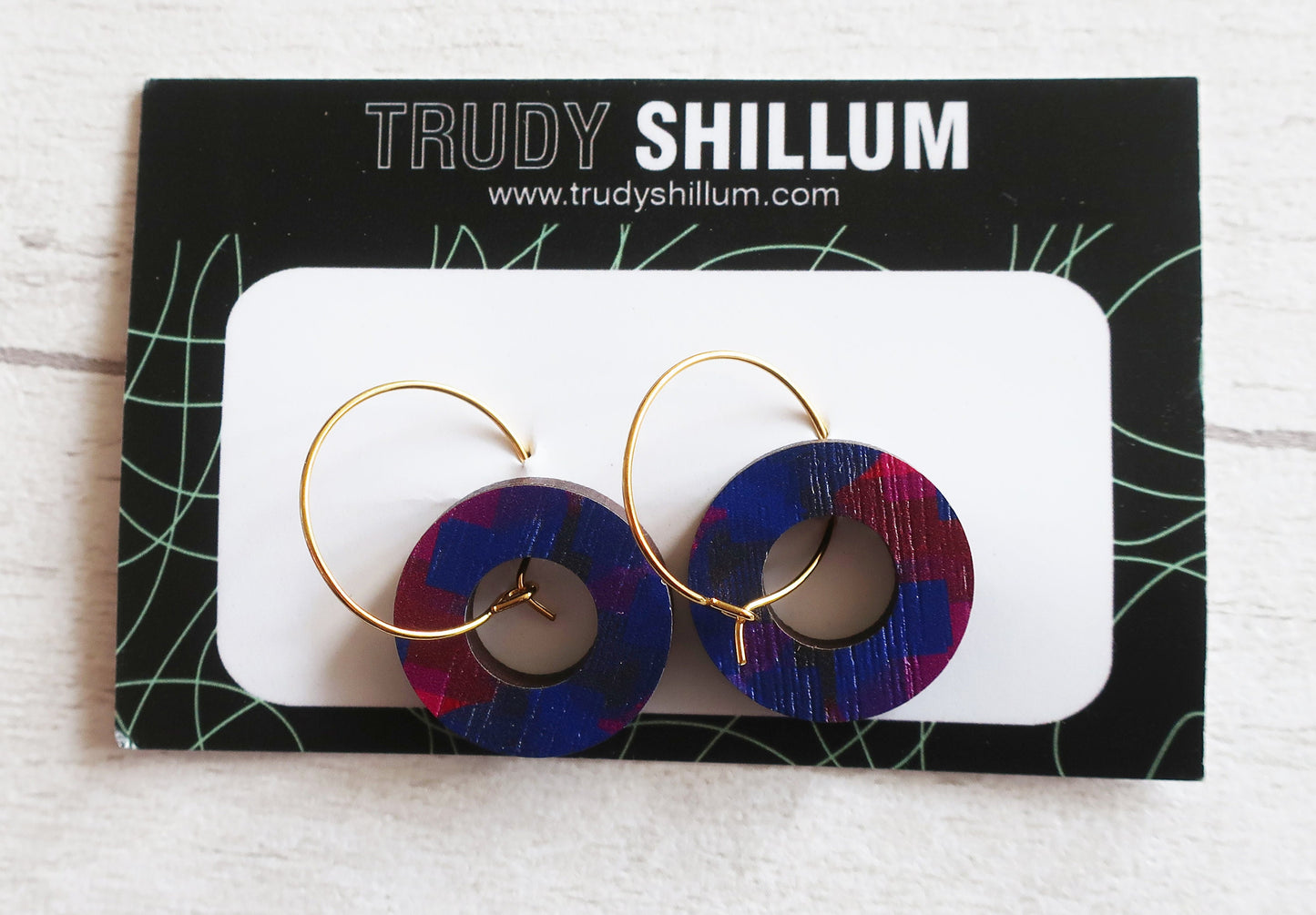 Trudy Shillum earrings on a branded card with a white background