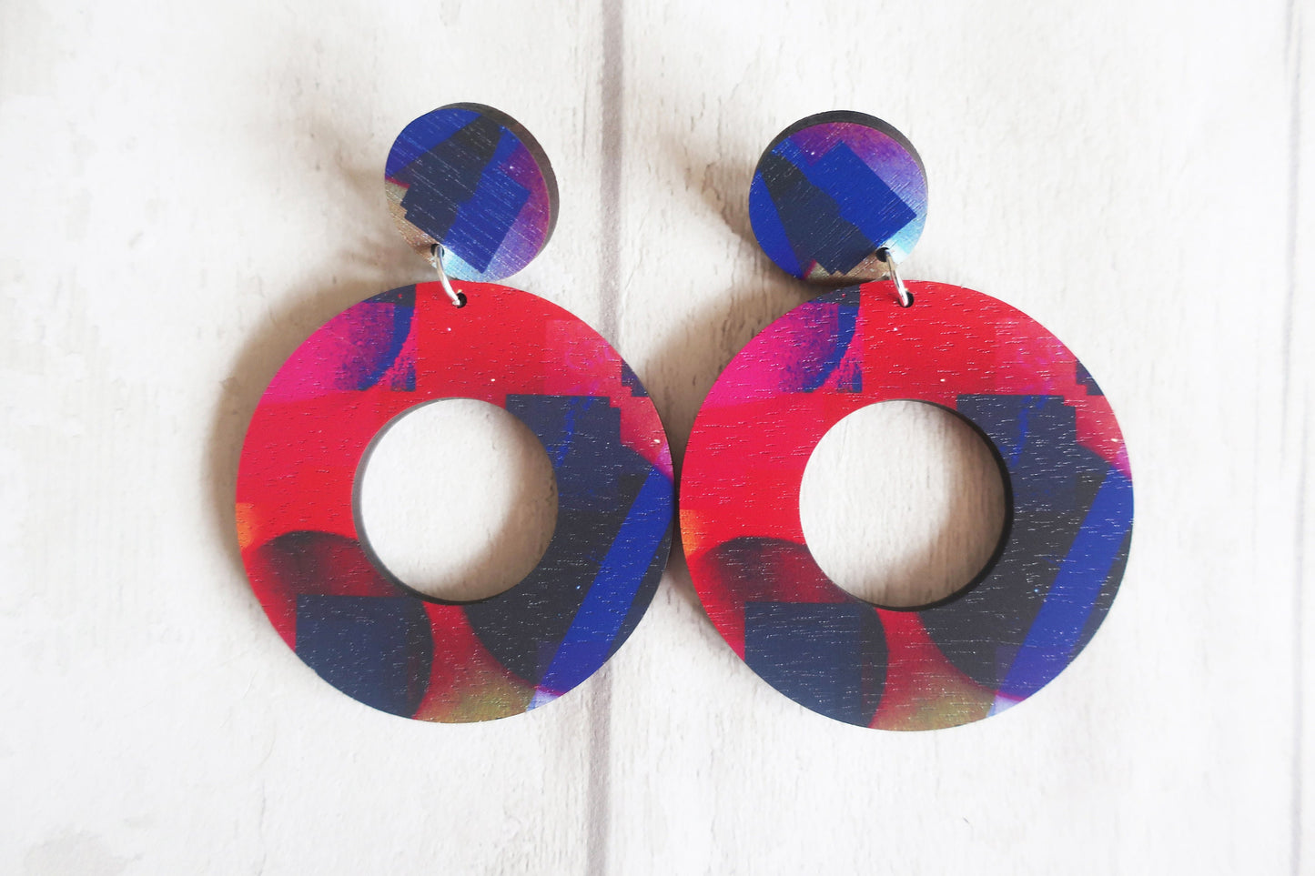 Colorful round earrings on a white background