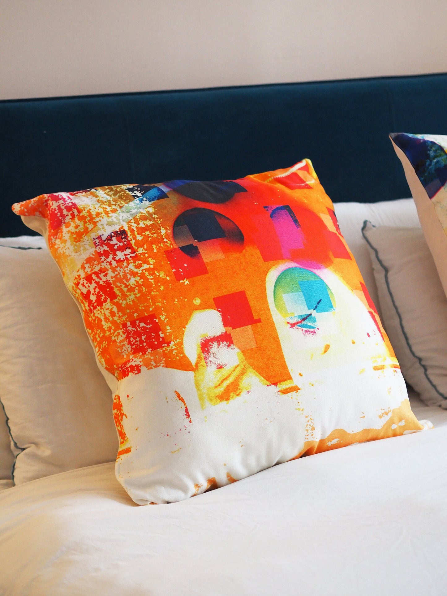 Colorful pillow with abstract design on a white couch