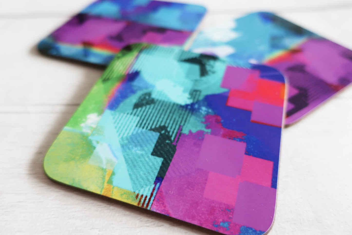 Colorful abstract coasters on a white surface