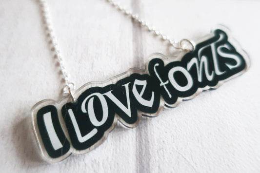 Necklace with 'I Love Fonts' pendant on a white background