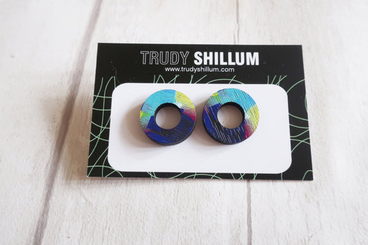 Colorful circular earrings on a Trudy Shillum branded card against a white background