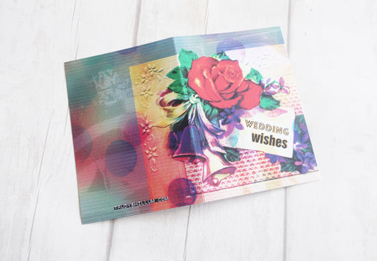 Colorful card with floral design and 'Wedding Wishes' text on a white wooden surface