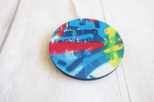Round colorful pendant on a white surface