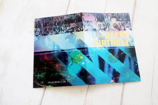 Colorful birthday card with abstract design on a white surface