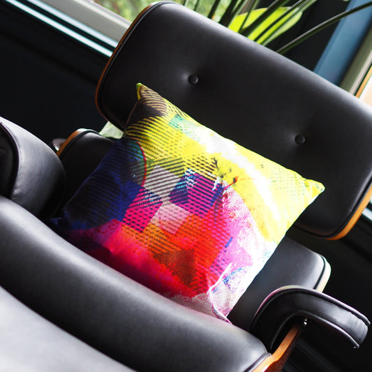 Colorful pillow on a car seat with a blurred outdoor background