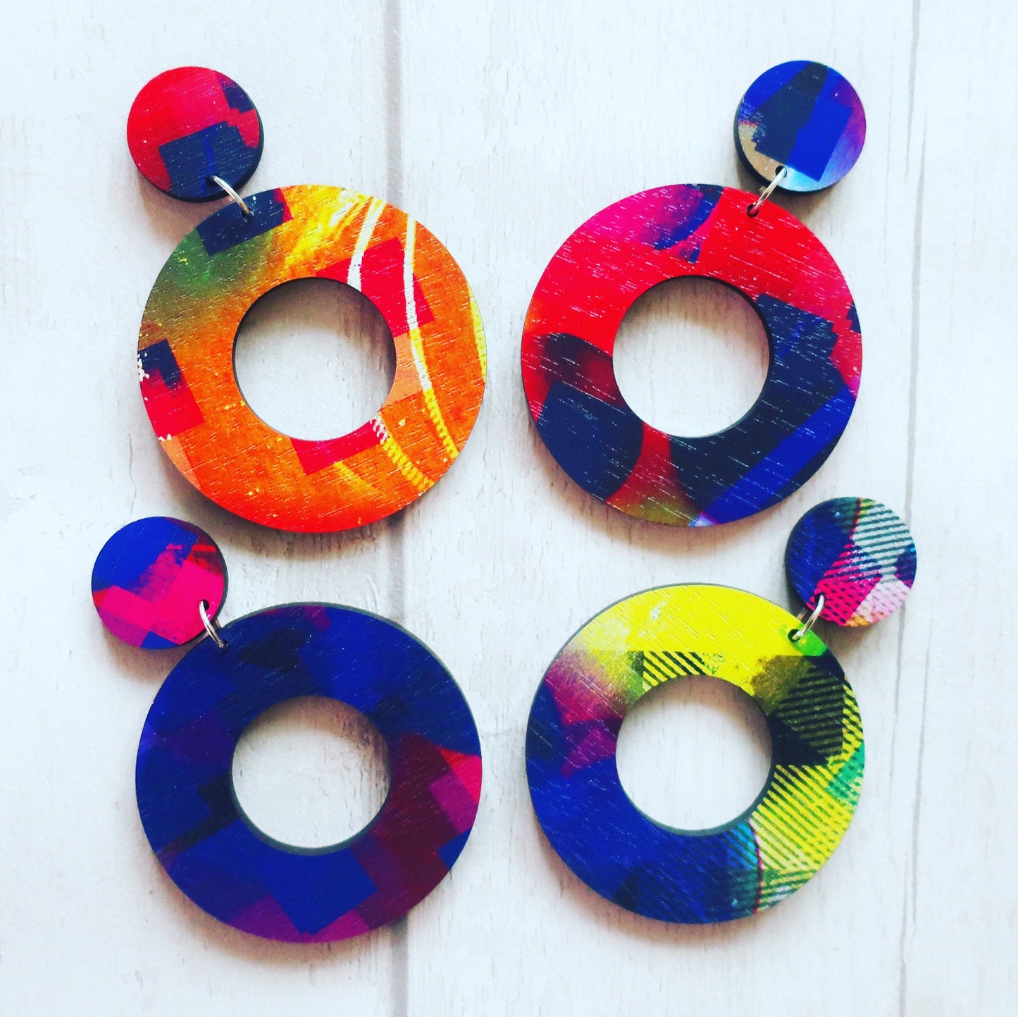 Colorful circular earrings on a white background