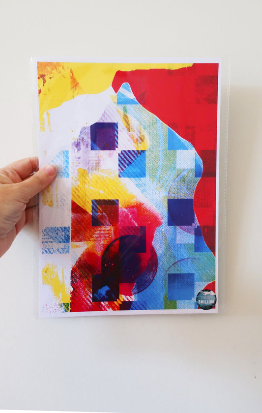 Colorful abstract art print held by a hand on a white background