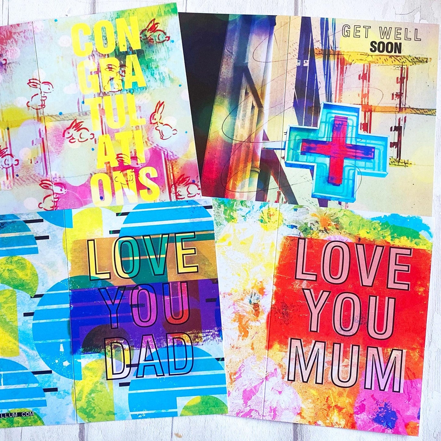 Colorful greeting cards with text and abstract designs on a white background