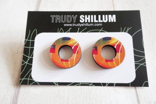 Colorful circular earrings on a Trudy Shillum branded card.