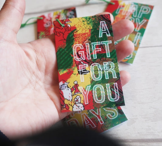A Christmas gift tag held in a hand