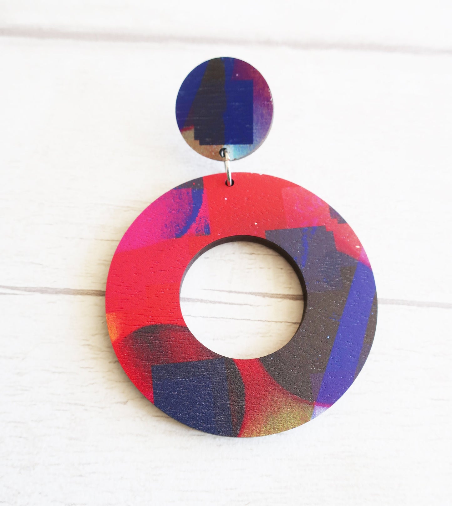 Colorful circular earring on a white background