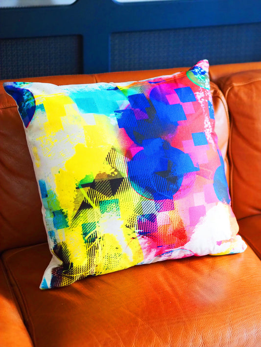 Colorful abstract-patterned pillow on a brown leather couch