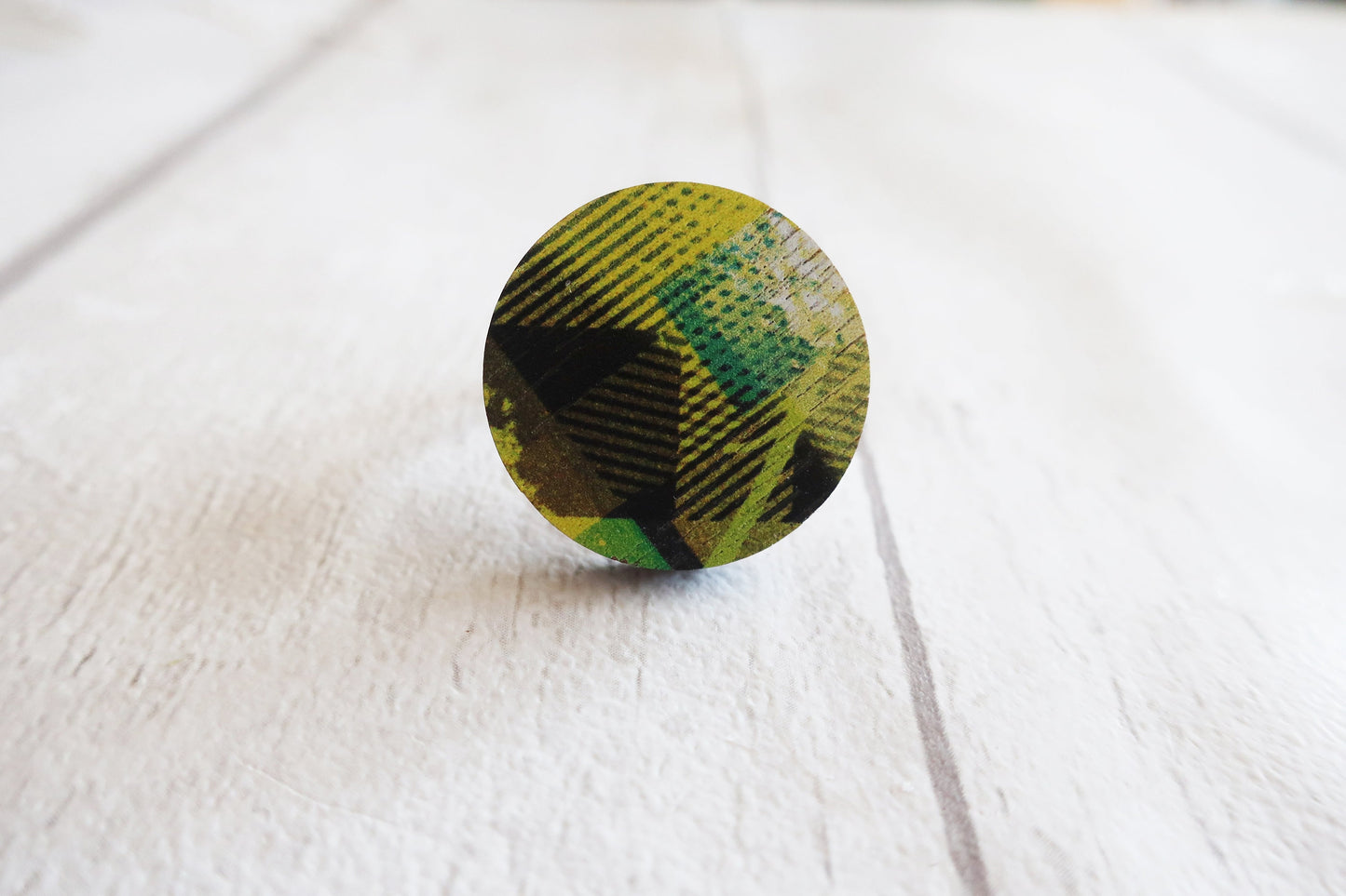 Round ring with yellow and black plaid pattern on a white background