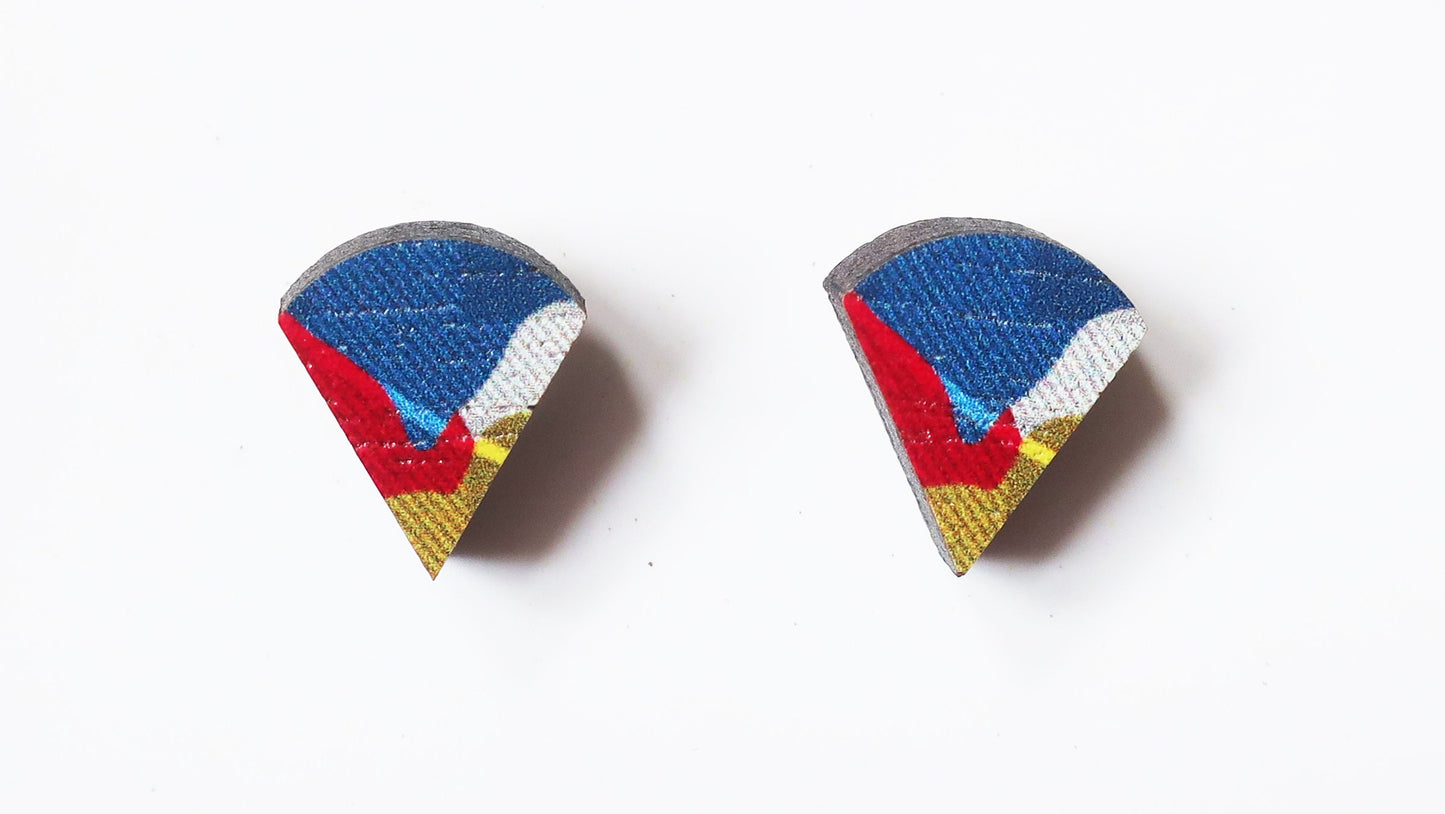 Pair of teardrop-shaped earrings with blue, red, and yellow design on a white background