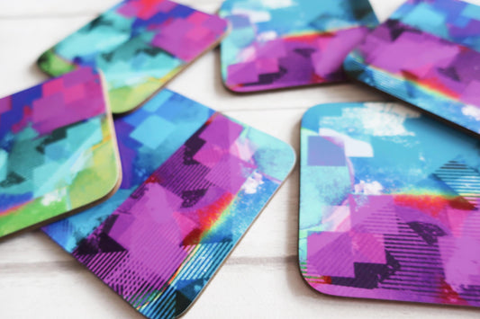 Colorful abstract patterned coasters on a white surface