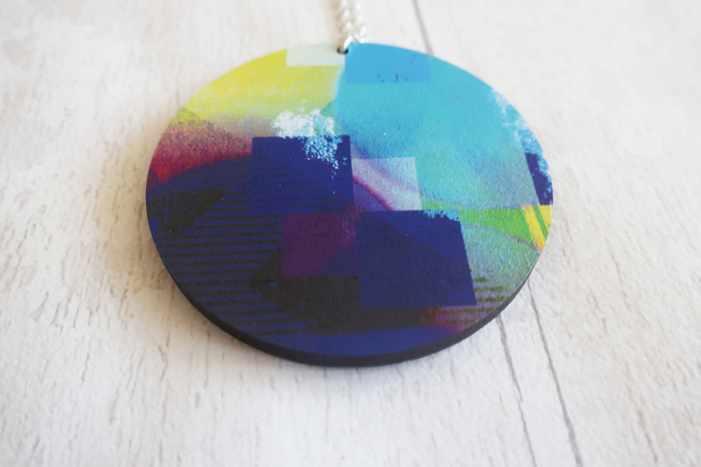 Round colorful pendant on a white surface