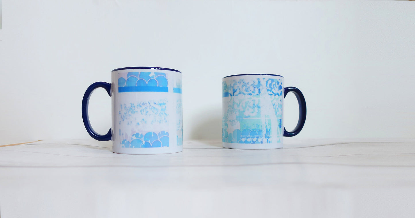 Two mugs with blue and white patterns on a white background