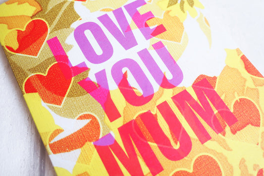 Card with 'Love You Mum' text and heart designs on a yellow background