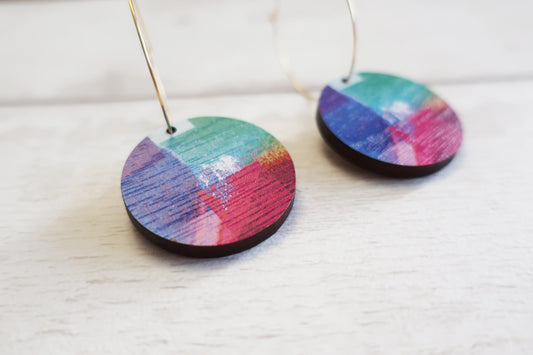 Colorful circular earrings on a white background