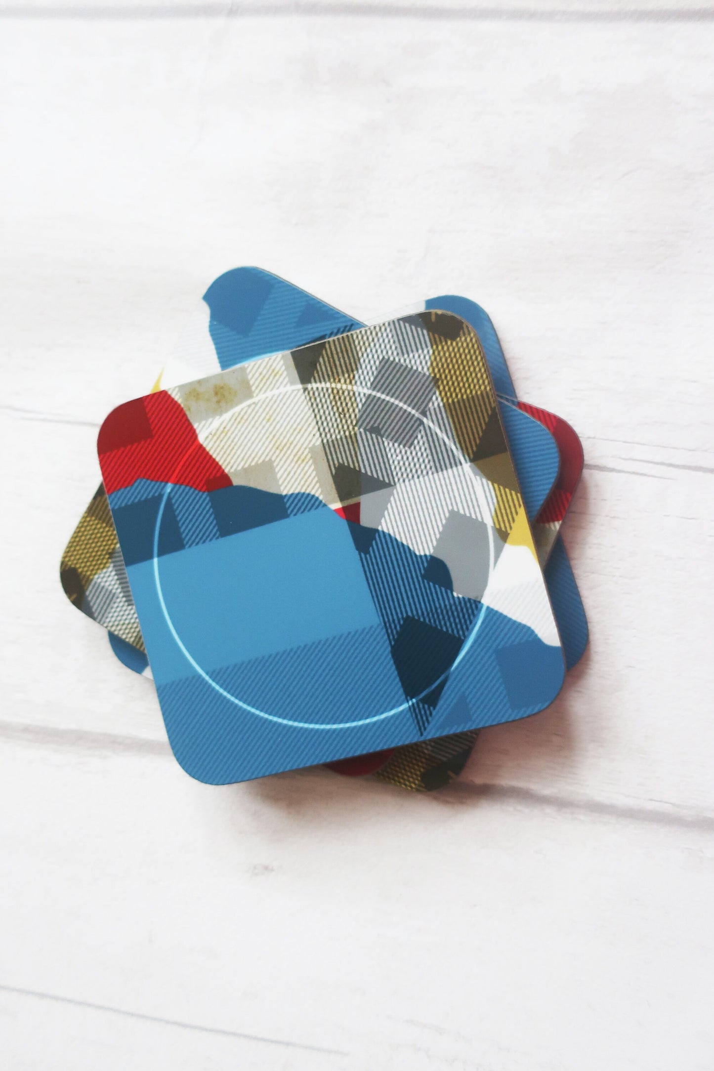 Set of colorful geometric coasters on a white surface