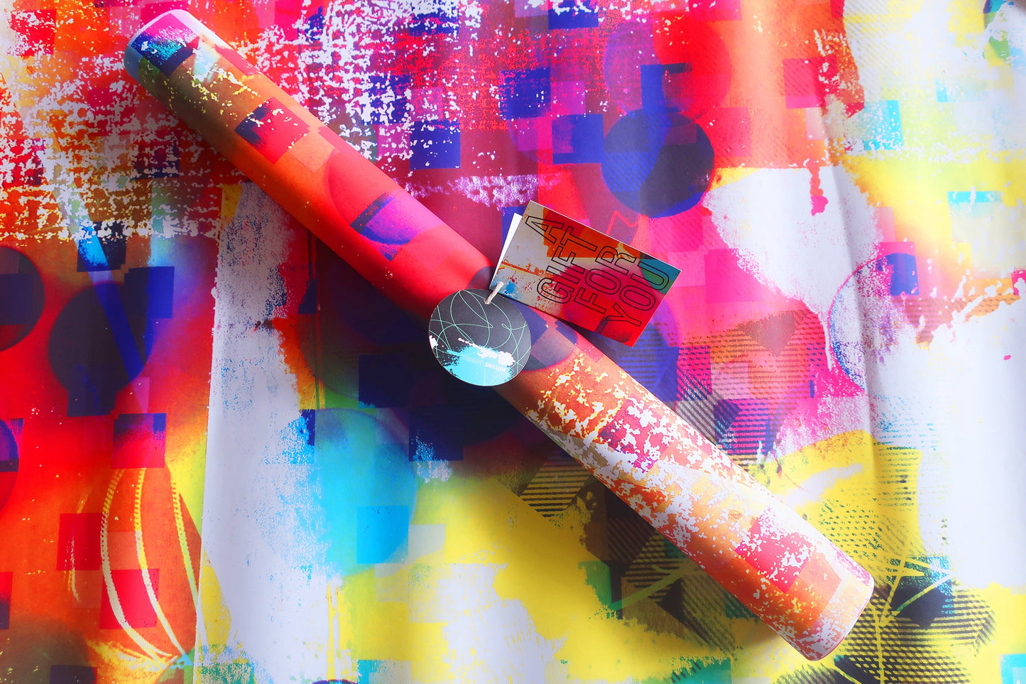Colorful abstract wrapping paper with a cylindrical object on top