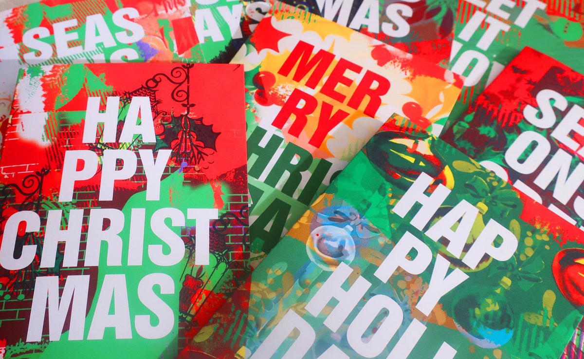 Colorful Christmas-themed cards with text and graphics.