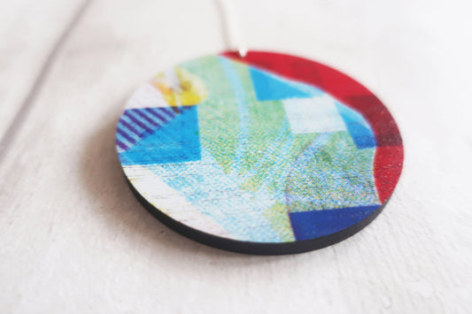 Round colorful pendant on a white background