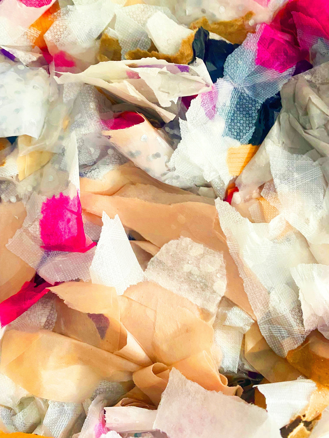 a photograph of ripped up paper scraps ready to be soaked for paper making