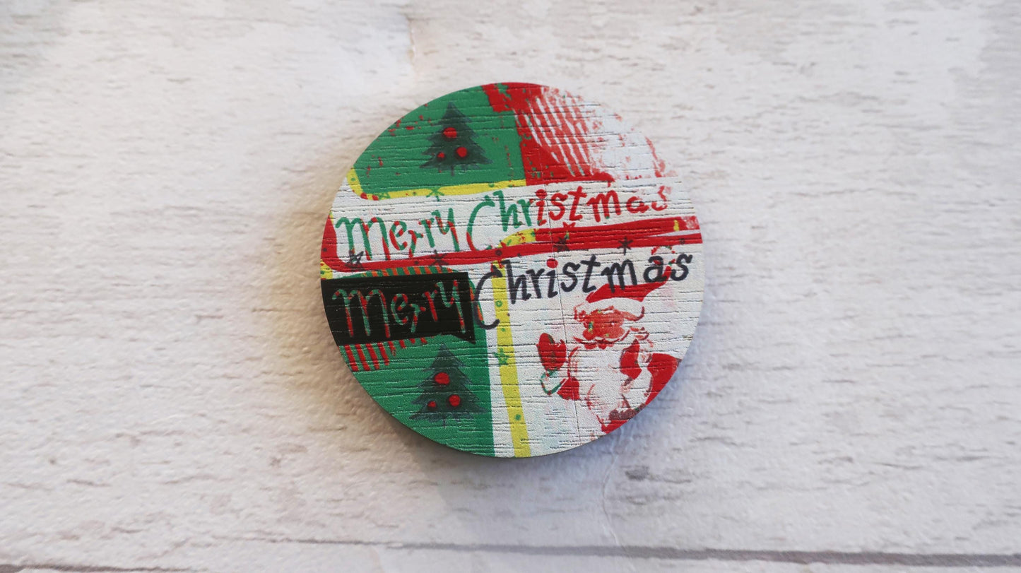 Round wooden badge with 'Merry Christmas' text on a white textured background