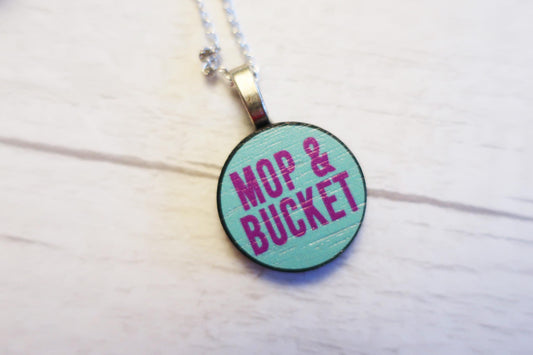 Necklace with a round pendant featuring 'Mop & Bucket' text on a light background