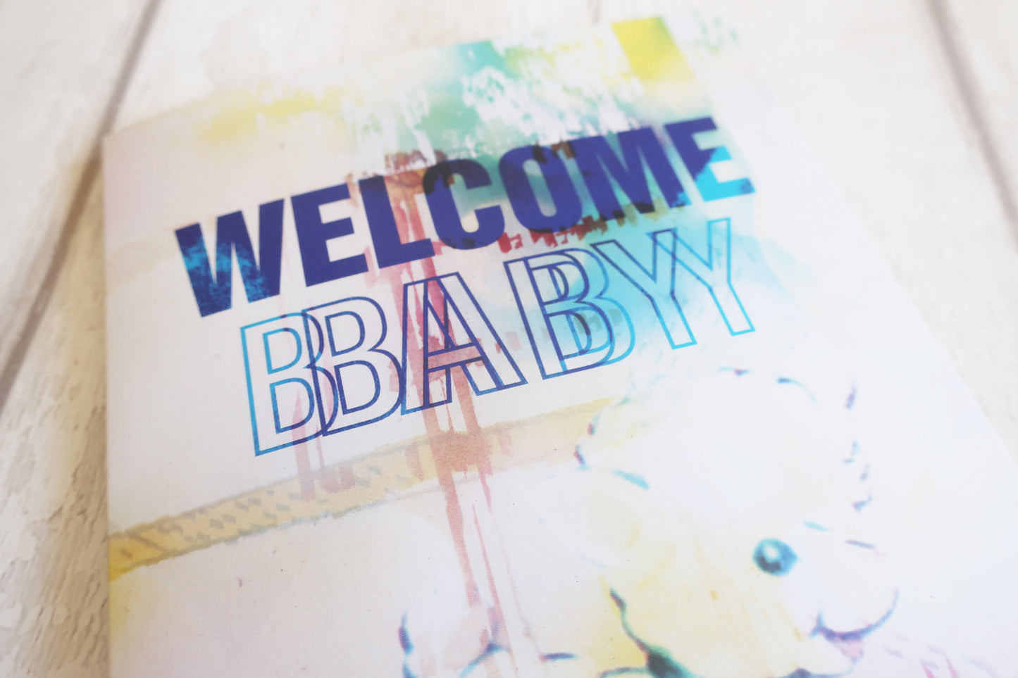 Colorful card with 'Welcome Baby' text on a light background