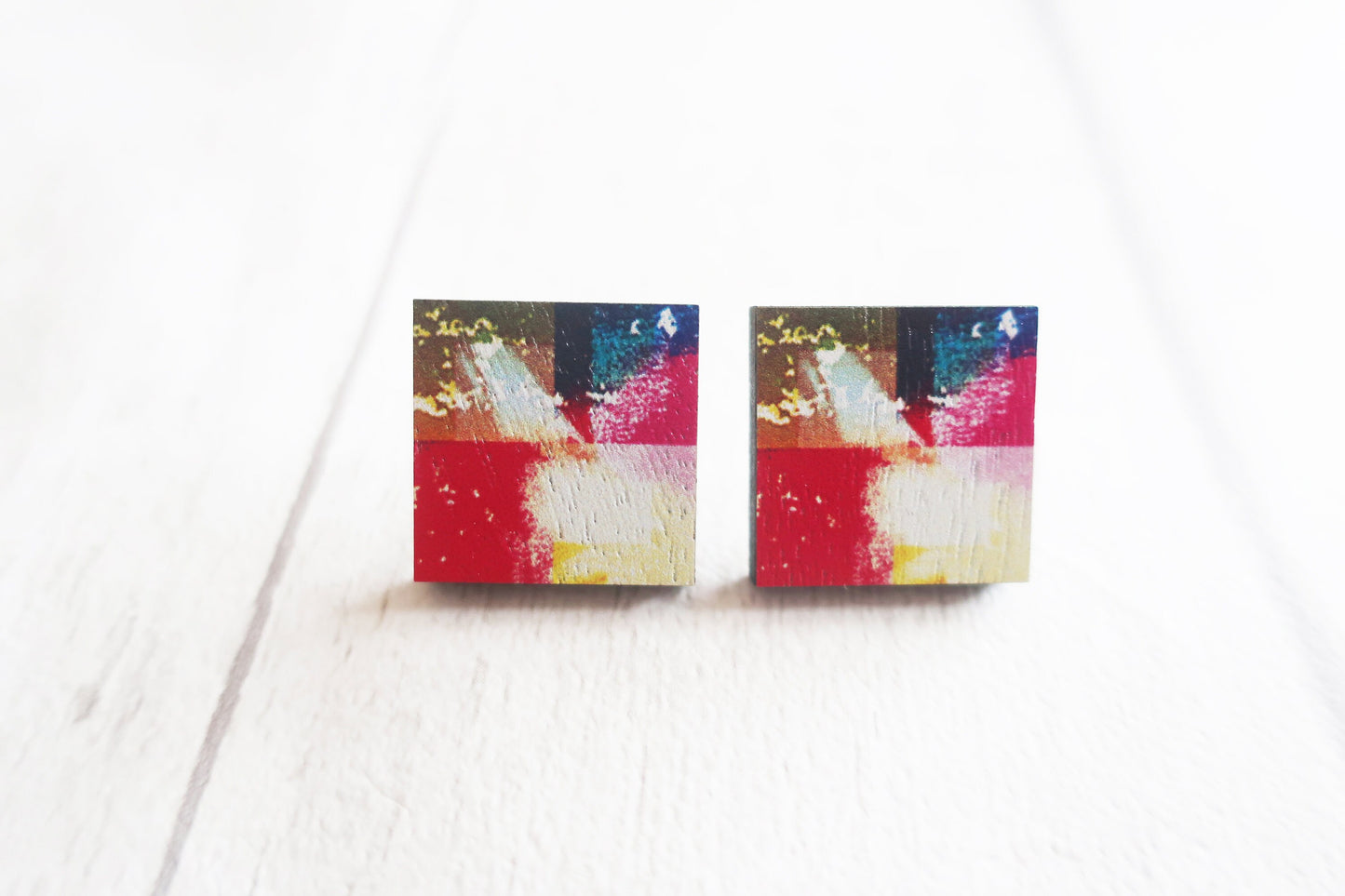 Colorful abstract square earrings on a white background