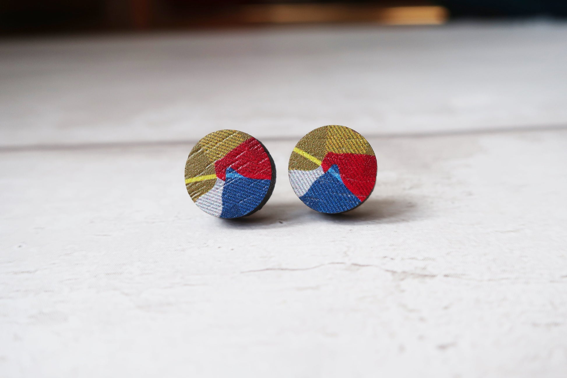 Colorful round earrings on a white surface