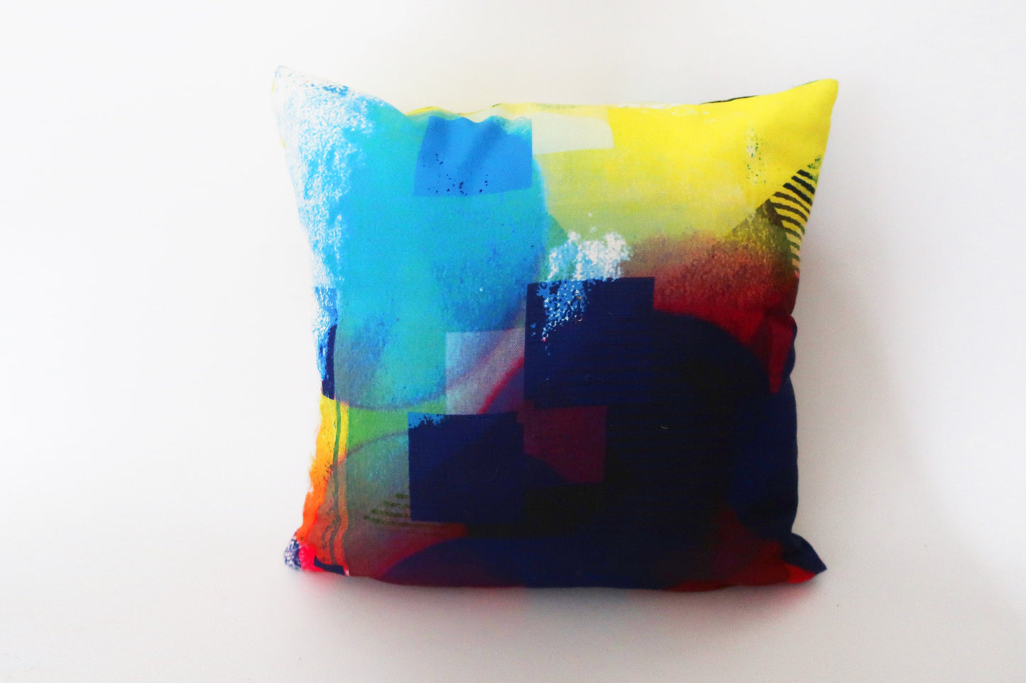 Colorful abstract-patterned pillow on a white background
